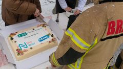 Nullføre og snø i luften til tross, kake må til på historisk veiåpning. Invitert til å forsyne seg først var personellet fra brann, helse og politi, som var til stede under åpningen.