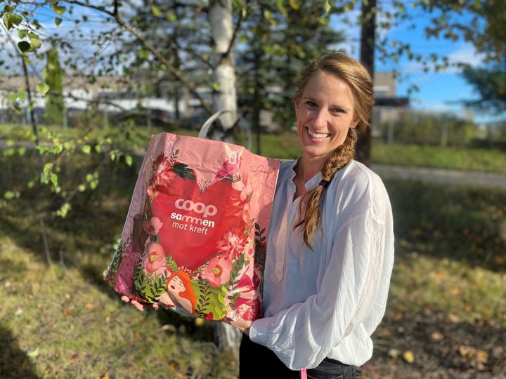 Det rosa handlenettet vises frem av Carina Hansen, prosjektleder i sponsoravdelingen i Coop Norge. Foto: Coop.