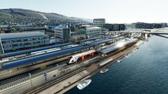 Utbyggingen i Drammen omfatter 10 kilometer nytt dobbeltspor og fornyelse av Drammen stasjon. Plattformtakene blir kledd med solceller som vil forsyne både Drammen og Gulskogen stasjoner med fornybar energi. (Illustrasjon: Norconsult og Baezeni for Bane NOR)