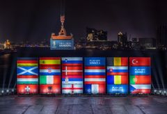 Port workers in Hamburg stack containers with flags of the EURO 2024 teams in accordance with the Final Draw.