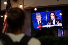 Two candidates for the US presidency. A person stops to watch a screen displaying the US Presidential debate between Vice President and Democratic presidential candidate Kamala Harris and former US president and Republican presidential candidate Donald Trump in Washington, DC, on September 10, 2024.