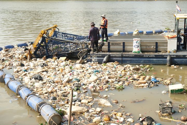 A waste collection vessel operated by everwave that collects plastic and debris from a river in Cambodia, thereby reducing the flow of waste into the ocean.
