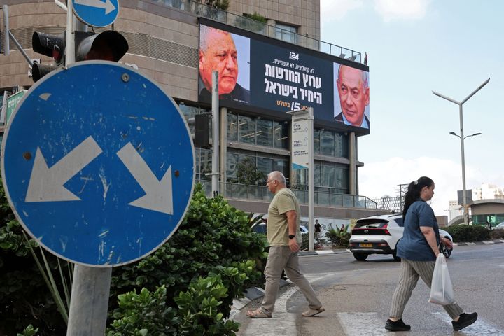 Pedestrians walk past an advertisement featuring Israel's Prime Minister Benjamin Netanyahu (R) of the Likud party and the country's former chief of the general staff and leader of the Yasher centrist political party Gadi Eisenkot, along a street in Ramat Gan on September 23, 2026. Israel heads to the polls on October 27 in its first election since the October 7, 2023, Hamas-led attack, in what is seen as a referendum on Netanyahu. (Picture: Jack Guez/AFP/DNA)