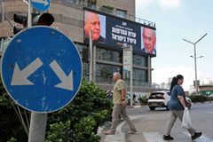 Pedestrians walk past an advertisement featuring Israel's Prime Minister Benjamin Netanyahu (R) of the Likud party and the country's former chief of the general staff and leader of the Yasher centrist political party Gadi Eisenkot, along a street in Ramat Gan on September 23, 2026. Israel heads to the polls on October 27 in its first election since the October 7, 2023, Hamas-led attack, in what is seen as a referendum on Netanyahu. (Picture: Jack Guez/AFP/DNA)