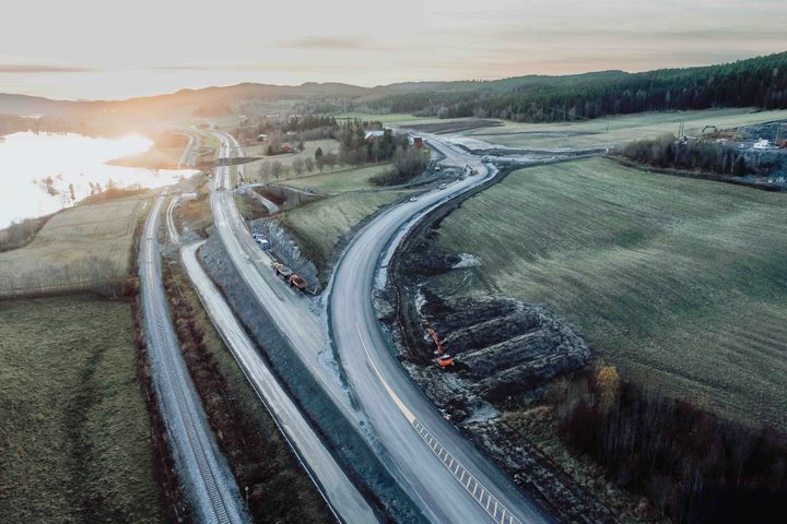 Dronebilde fra strekningen. Rasområdet er til venstre bak i bildet, og den midlertidige veien går på oversiden av bebyggelsen.