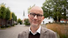 Portrettbilde av en mann i grå dress.