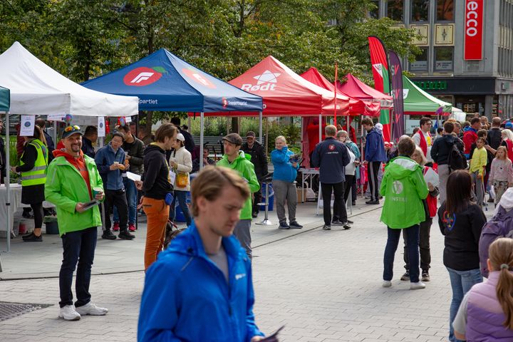 fargerike parti-telt plassert ute på gata. mennesker som går rundt.
