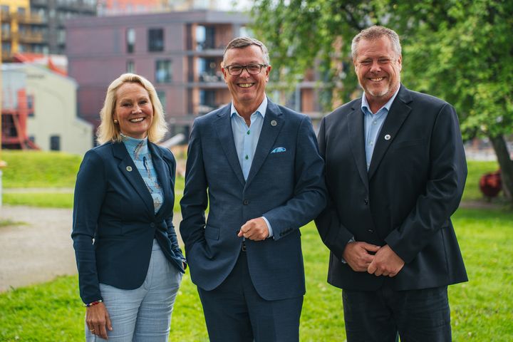 Tre rektorer, to menn og en kvinne, på sommerlig universitetsområde.