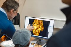 Arkeologene ser nærmere på inngraveringen på gullgubben, som nylig ble funnet på Klepp av Kjetil Særheim.