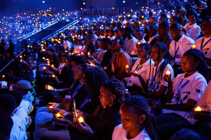 Rwandans take part in a candle lit vigil on the first of 100 days of remembrance as Rwanda commemorates the 30th anniversary of the Tutsi genocide.