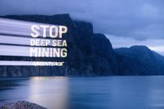 Greenpeace setter snart seil for en arktisk ekspedisjon for å forske på truede arter i havområdene norske myndigheter har åpnet for gruvedrift. På bildet: Greenpeace projiserte lysbilder med teksten «Stopp gruvedrift på havbunnen» på en fjellvegg i Lysefjorden.