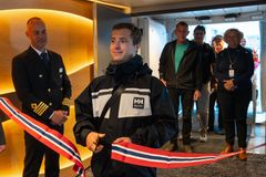The first guest on board Havila Pollux cuts the ribbon before the maiden voyage.