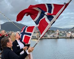 Crew from Havila Pollux waves goodbye to Bergen on the maiden voyage.