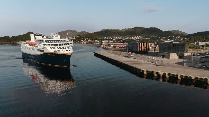 Havila Capella in front of Havila Voyages' headquarters at Mjølstadneset in Fosnavåg, Norway