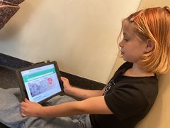 Jente i 6. klasse leser om Arbeiderpartiet i Lille norske leksikon på en ipad