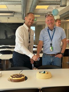 GODT HUMØR: Prosjektleder Eivind Søgaard i Bravida og prosjektsjef Stein Johnsen i Skanska skjærer første biten av marsipankaka.
