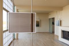 A photograph of blinds in Paimio Sanatorium placed on metal rods in a living room.