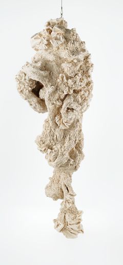 White textile object hanging from the ceiling.