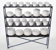 A shelf with white objects made by bone china, unglazed and white.