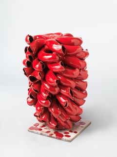 A ceramic object glazed in bright red.
