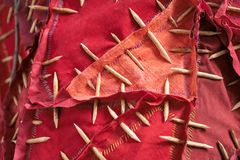 Close up of red objects in textile and wood hanging down from the ceiling. The material is extra visible.