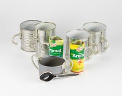 Cups with handles made of tin cans and a spoon.
