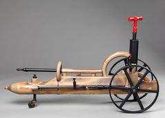 And object made by wood-fired stoneware with black metal wheels.