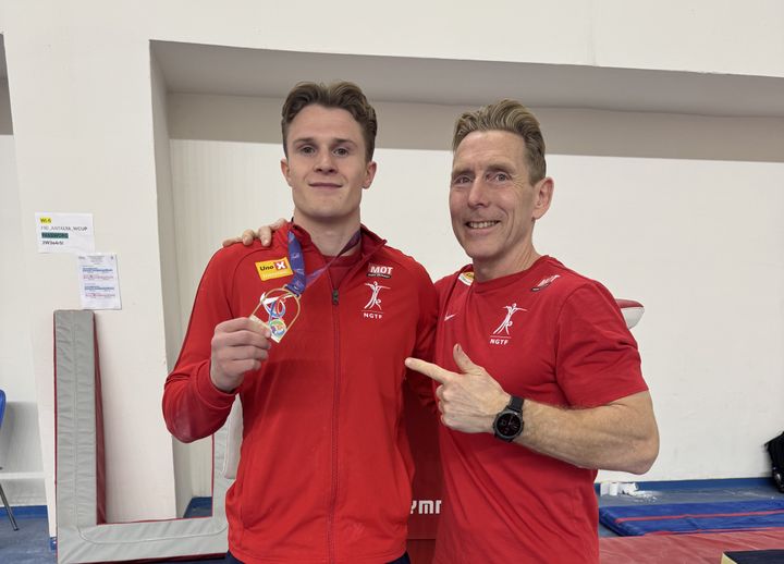 Sebastian Sponevik med gullmedaljen sammen med trener Espen Jansen.