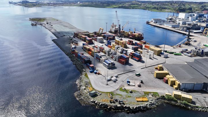 Luftfoto av containerterminalen på Husøy ved Karmsund Havn med containere, kraner og kaiområder.