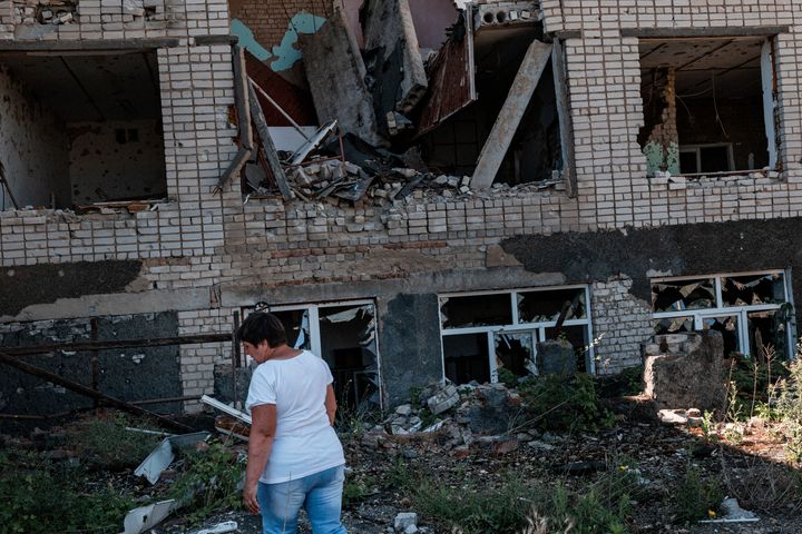 Head woman, Valentina Chernenko, outside the village school and inside the remains of her office.