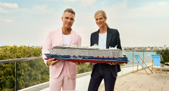 Robbie Williams holding a My Shiff cruise ship model