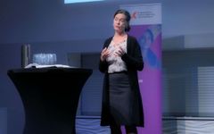 Ingjerd Espolin Gaarder holder et innlegg foran en HK-dir-rollup.