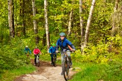 barn sykler på en skogsvei